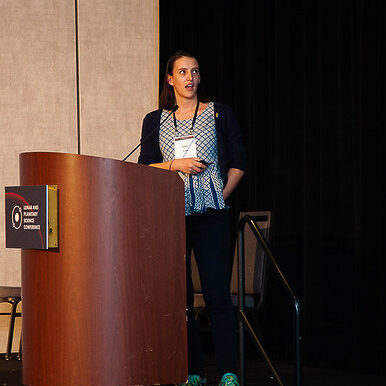Picture of Emily in front of the podium during her talk