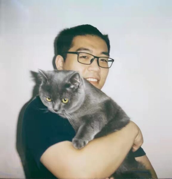 Photo of Jialong holding a cat